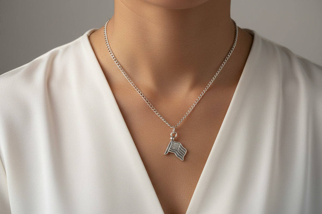 Gold necklace with an American flag pendant on a white background