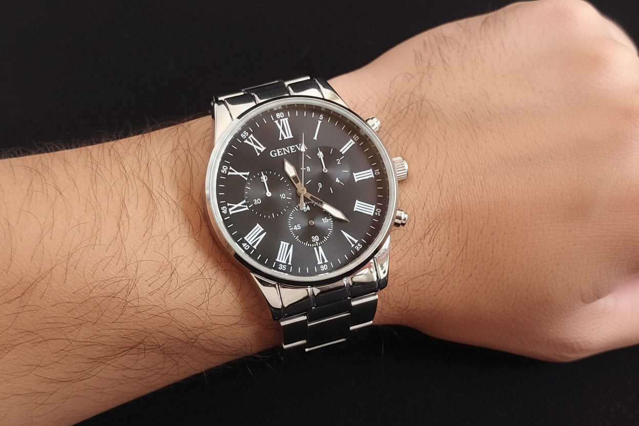 Wristwatch with black dial and silver case on a dark background